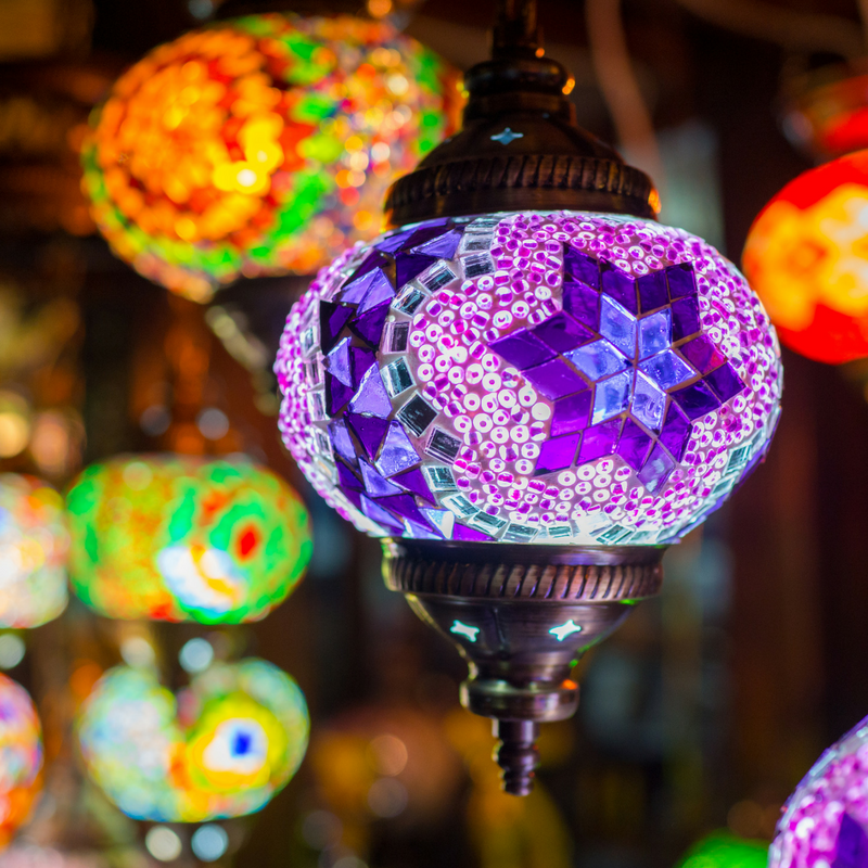 bright ornamental lights (purple in foreground and orange/green in background)