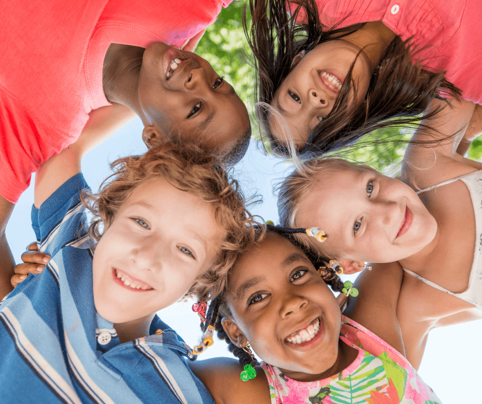 diverse smiley kids look down for birdseye view of camera
