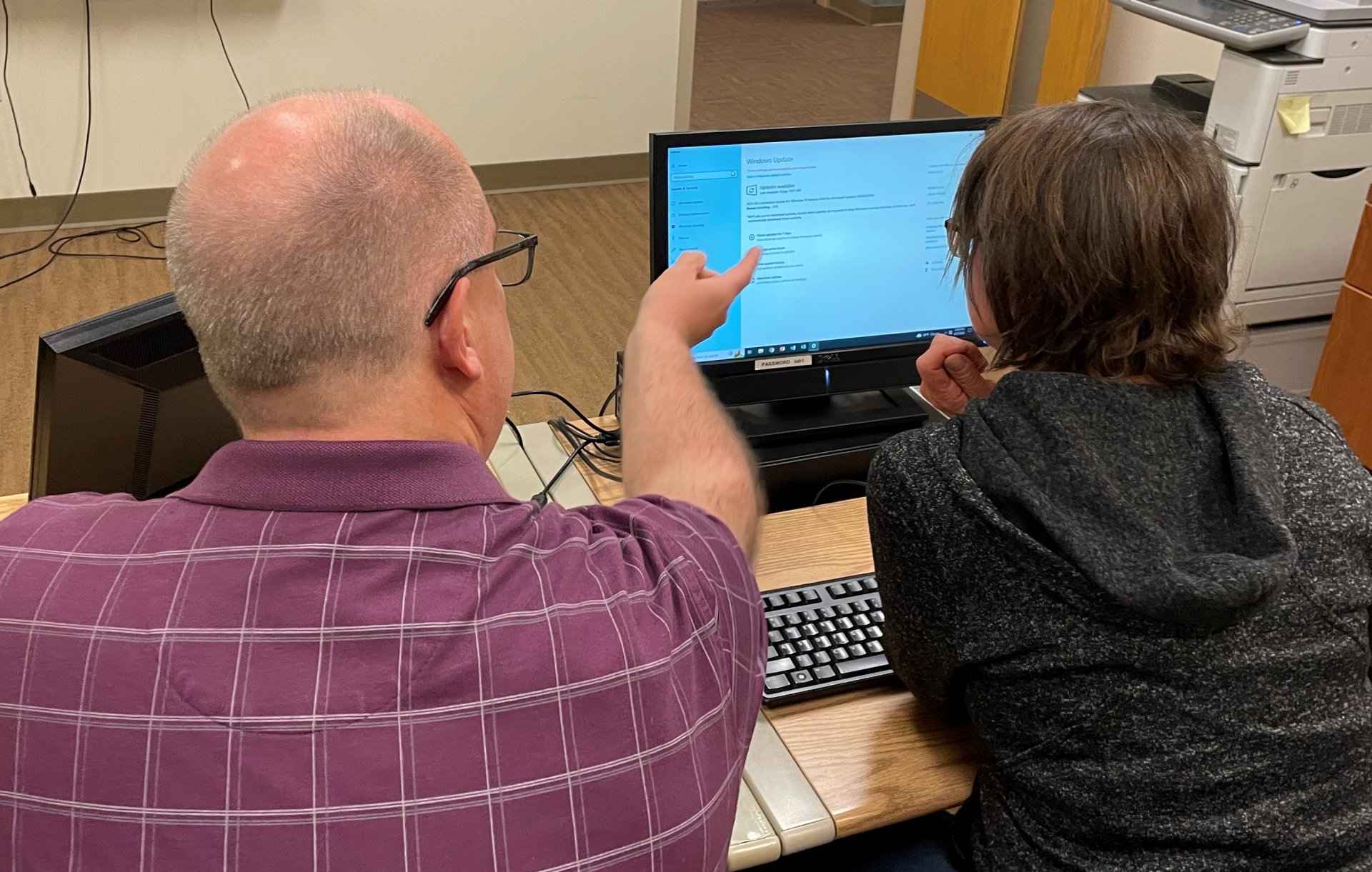 IOCP Employment Services team member Tim helps client *Beth with computer skills