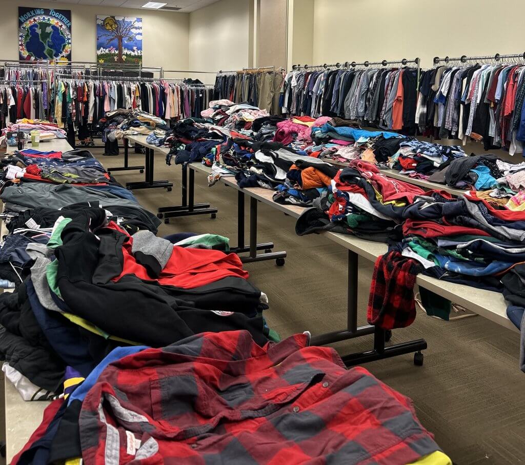 Racks and tables of clothes for clients at Resale Select